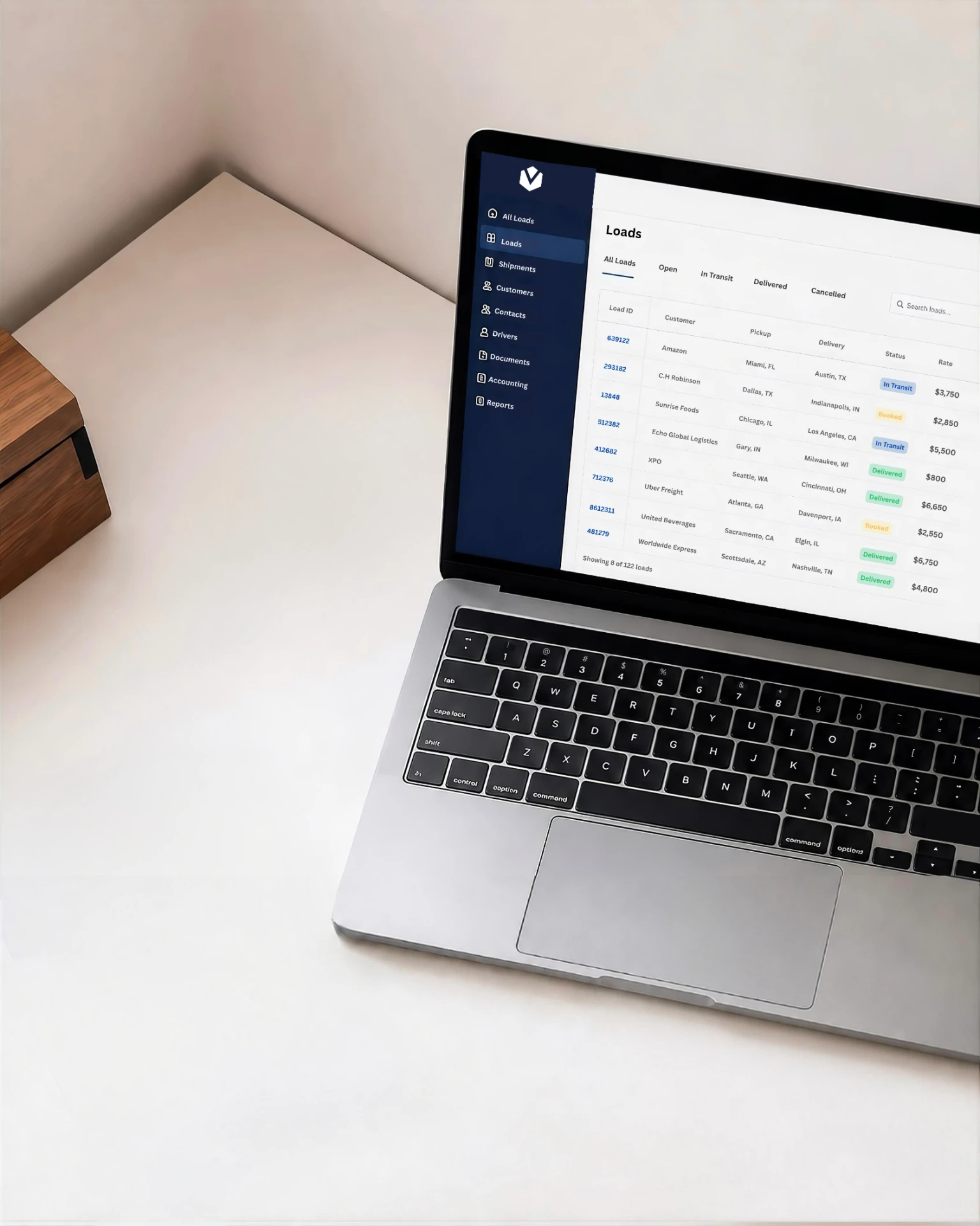 Broker reviewing load documents on a laptop