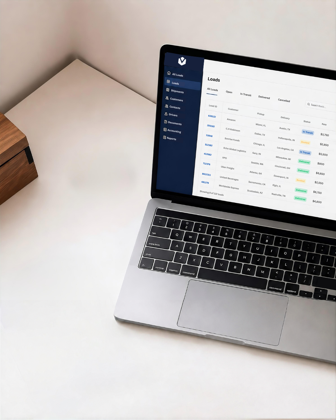 Broker reviewing load documents on a laptop